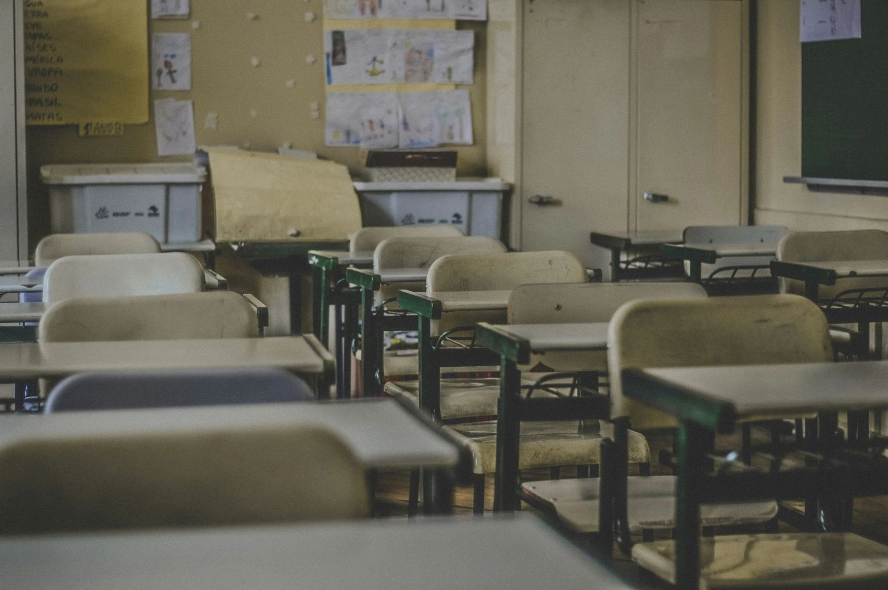 An empty modern classroom with rows of desks